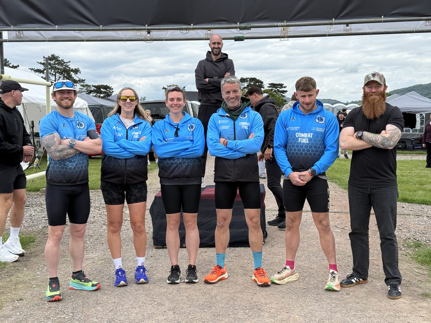 Team TC athletes in club kit lined up at the start of the RedOn Back Yard Ultra, with in-house rehab and nutrition staff alongside them