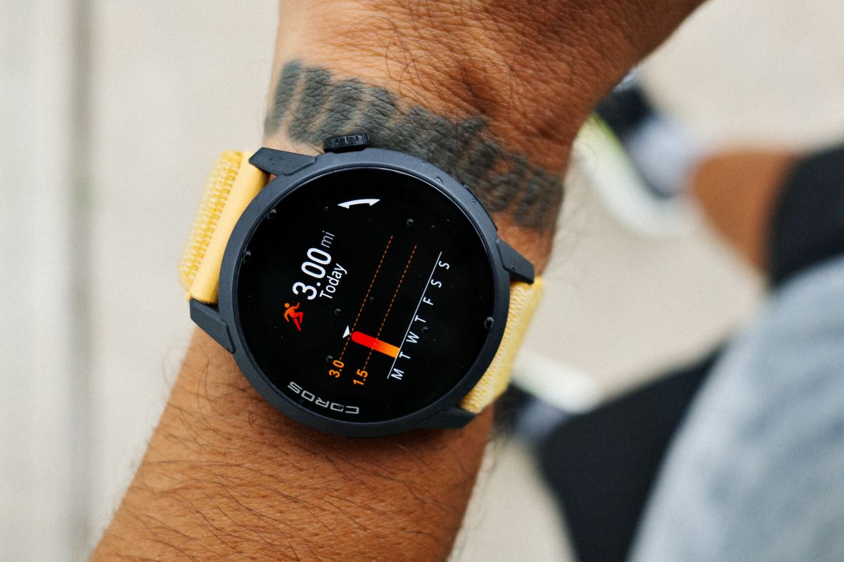 Close-up of a GPS running watch on a runner wrist showing three miles logged today